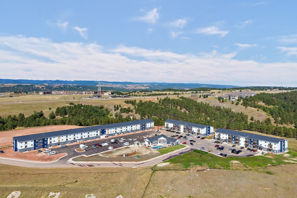 an aerial view of an office building and a parking lot