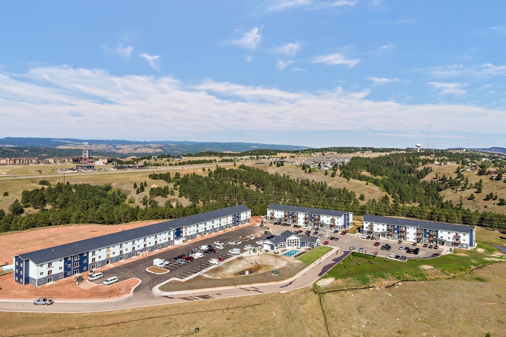 an aerial view of an office building and a parking lot