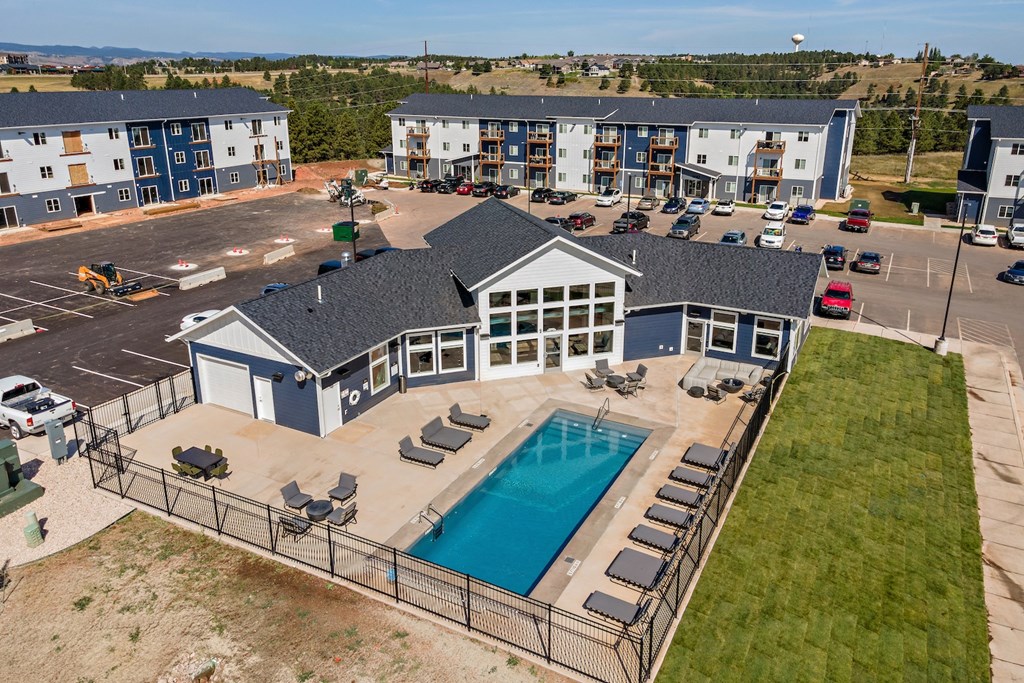 an aerial view of a building with a swimming pool