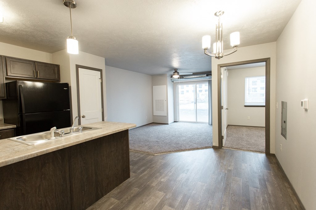an empty apartment with a kitchen and a living room