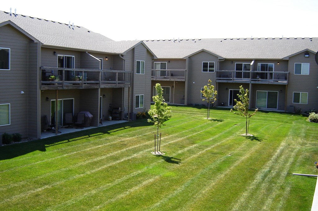 a large yard in front of an apartment building