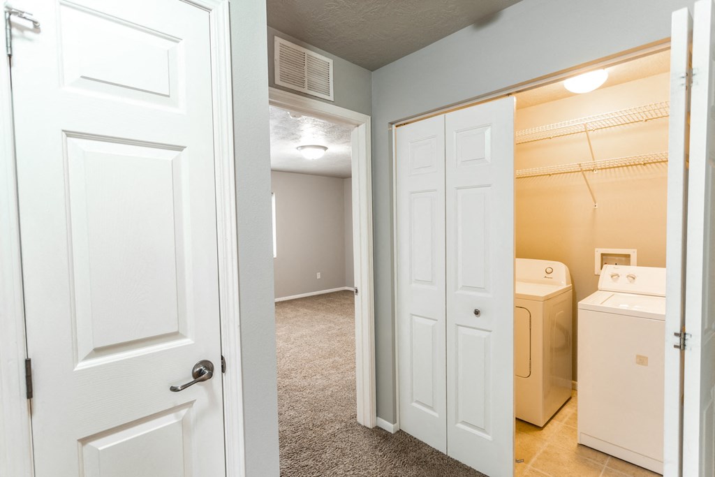 a renovated bathroom with a closet and a laundry room