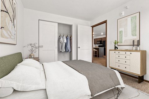 A bedroom with a bed, dresser, and mirror.