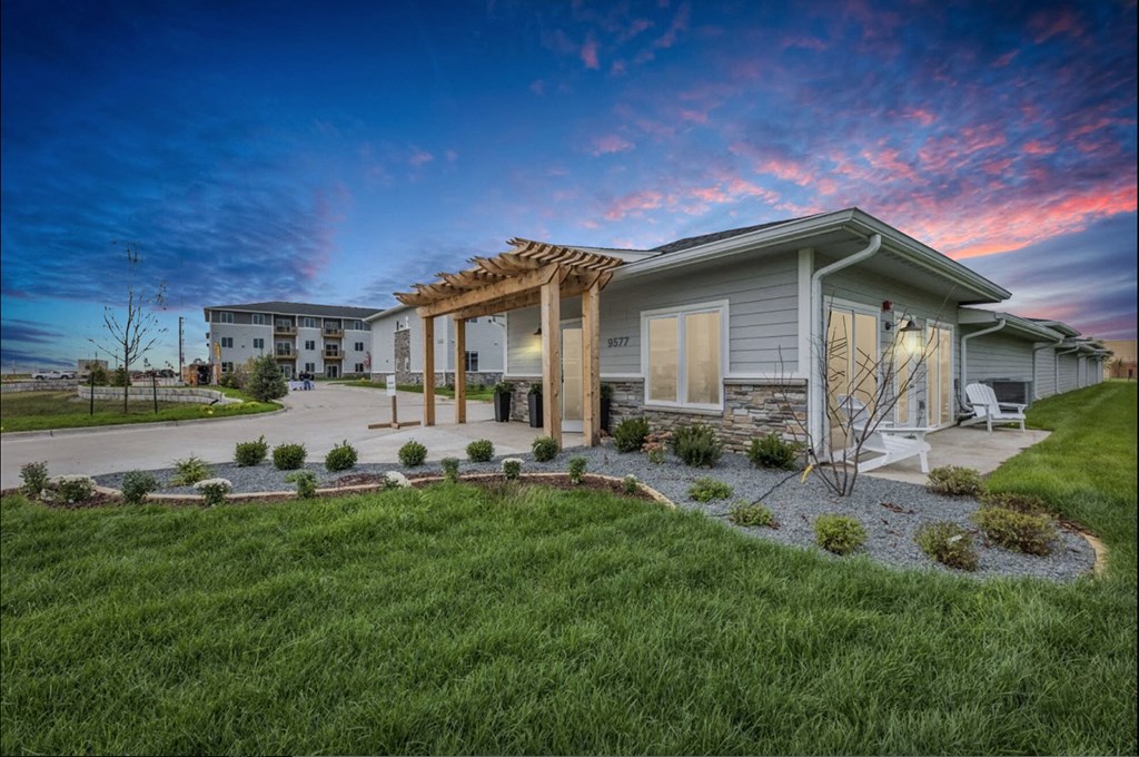 a home with a covered porch and a grassy yard