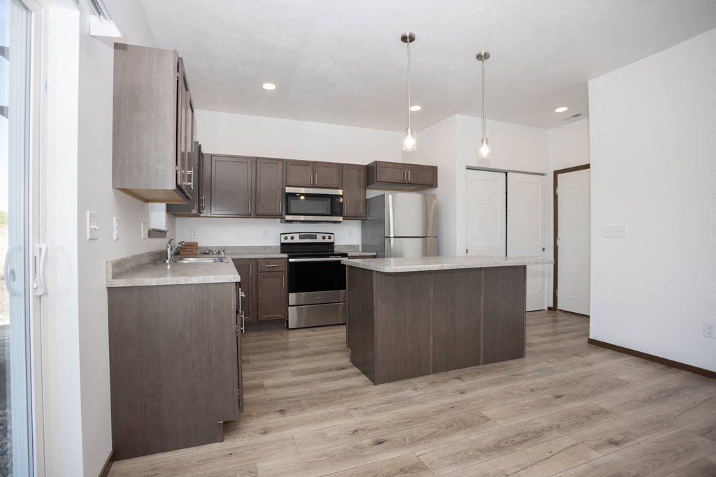 a kitchen with wooden cabinets and stainless steel appliances