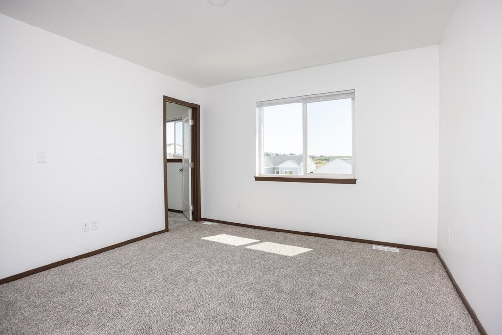 an empty room with a window and a door