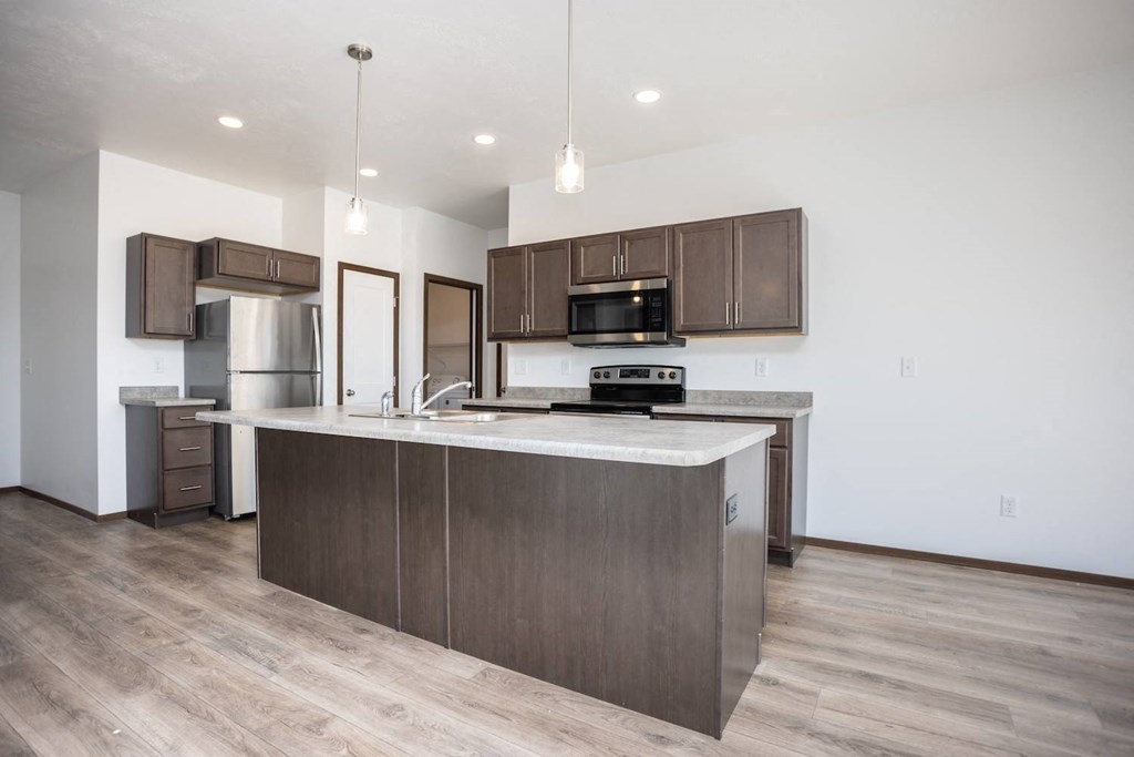 a kitchen with a large island in the middle