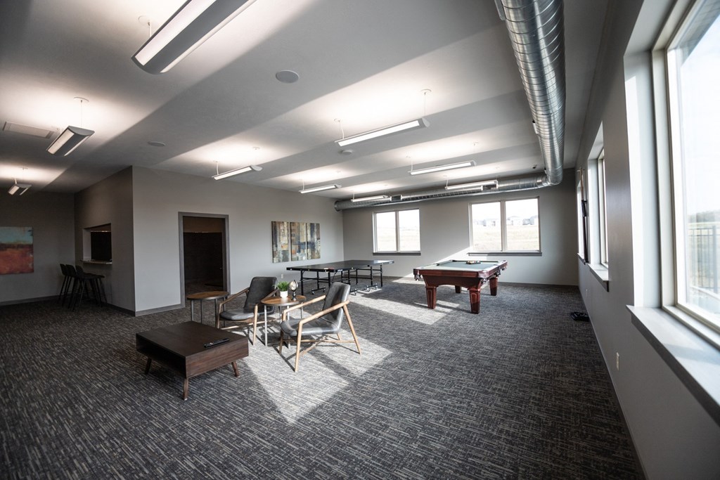 a large room with a pool table and tables in it