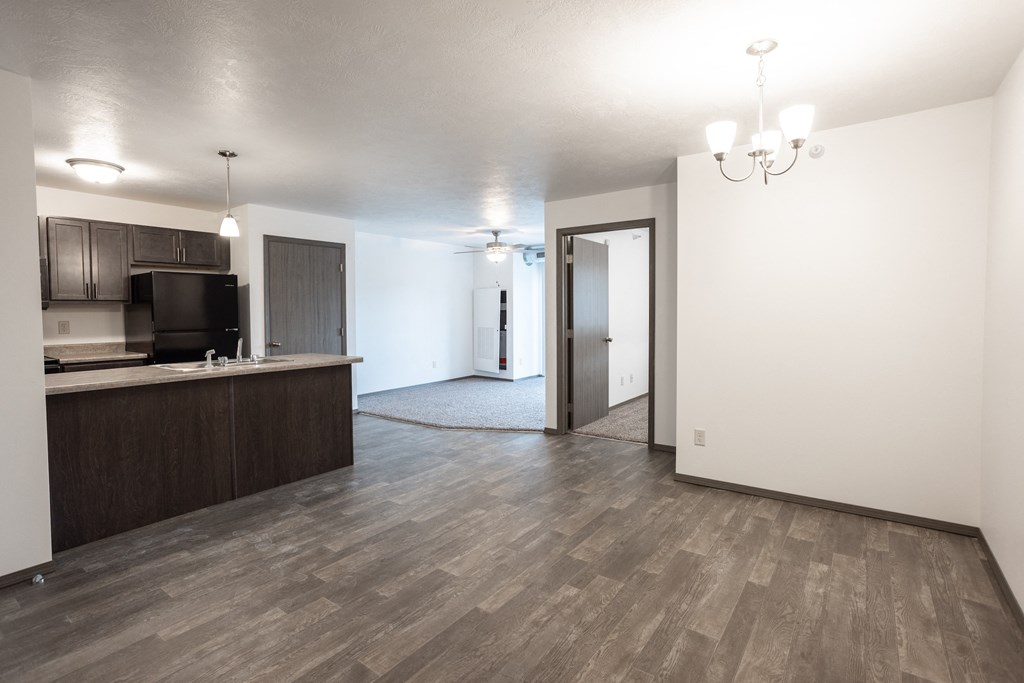an empty living room and kitchen in a new apartment