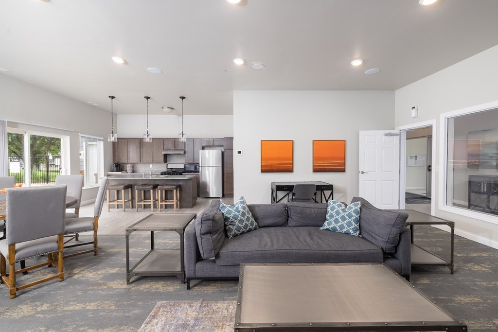 A modern living room with a grey couch and a wooden coffee table.