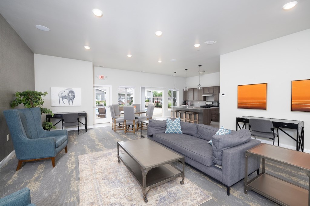 A living room with a grey couch and a blue chair.