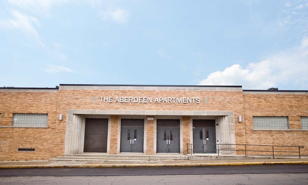 The Aberdeen Apartments is a brick building with three doors.