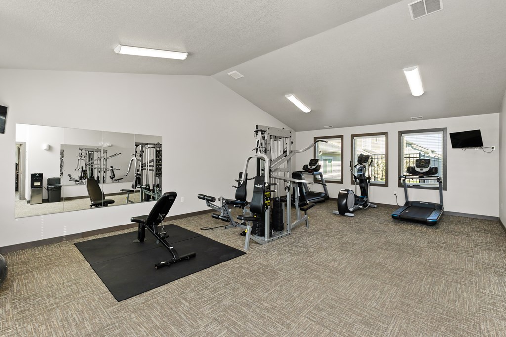 A spacious home gym with a variety of equipment.