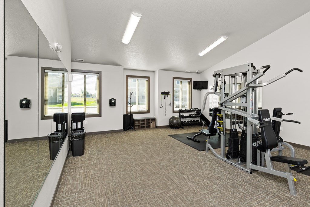 A well-equipped gym with a variety of machines and weightlifting equipment.