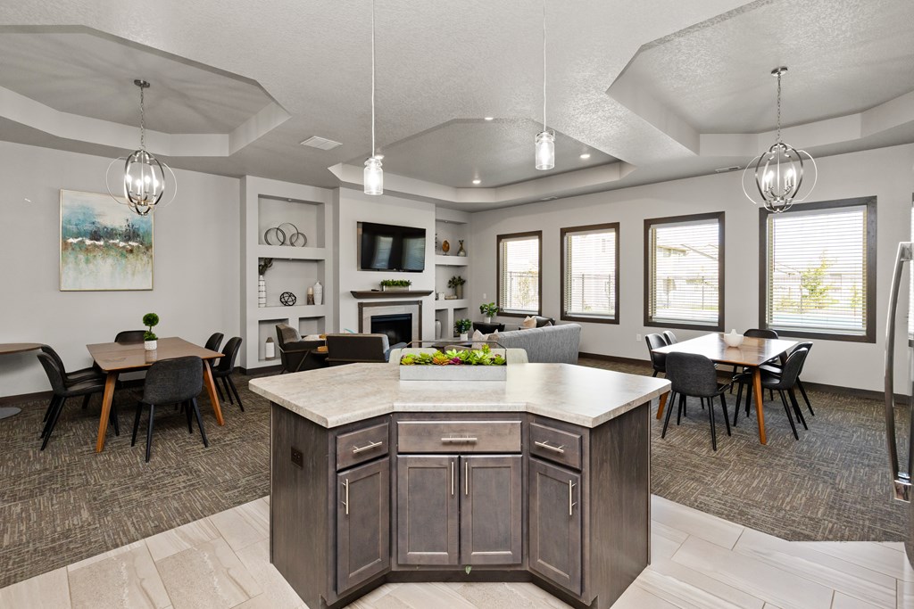 A kitchen with a large island and a dining table.