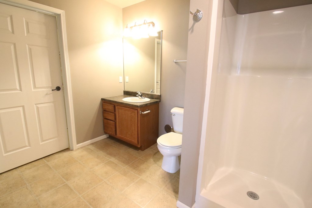 a bathroom with a toilet and a sink and a shower