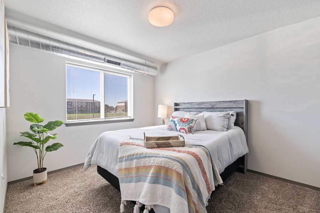 our apartments offer a bedroom with a bed and a window