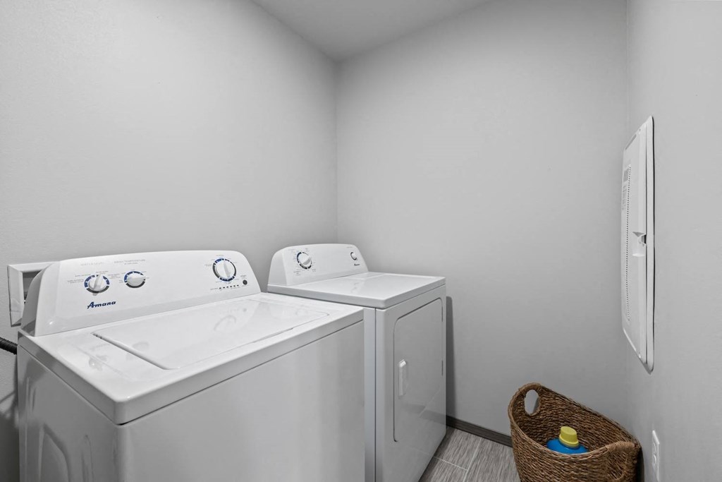 a washer and dryer in a laundry room with a basket