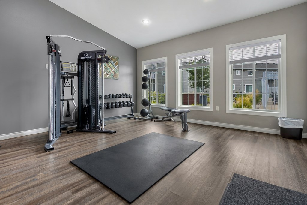 A spacious home gym with a variety of equipment.