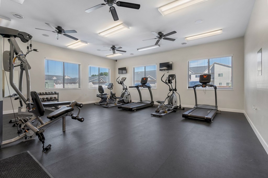A spacious home gym with a variety of exercise equipment.