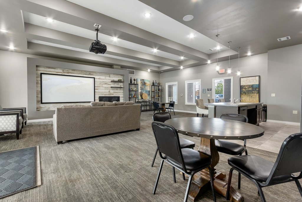 A modern living room with a grey sofa, a black coffee table, and a television.