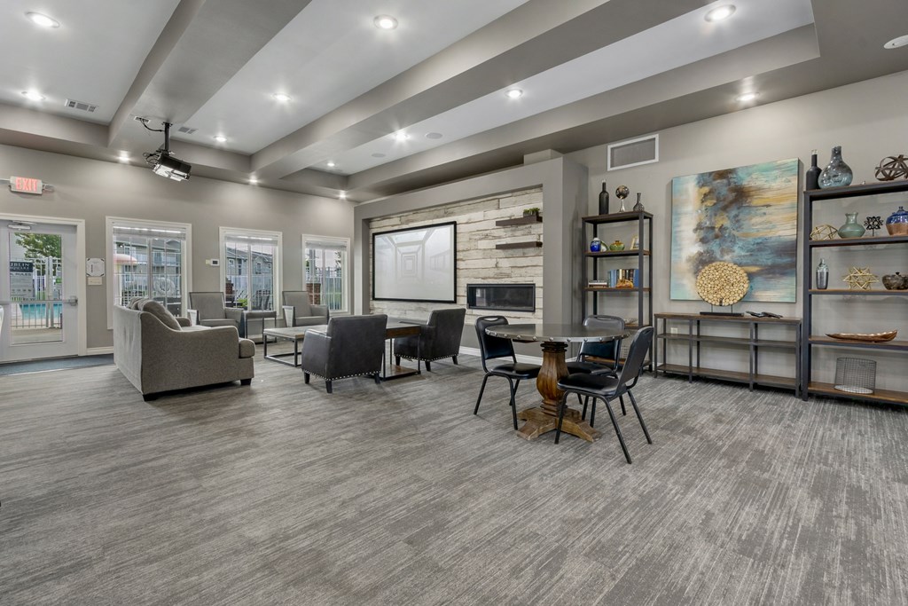 A modern living room with grey flooring and furniture.