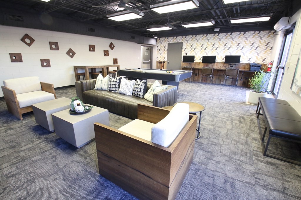 a seating area with couches and tables in a library