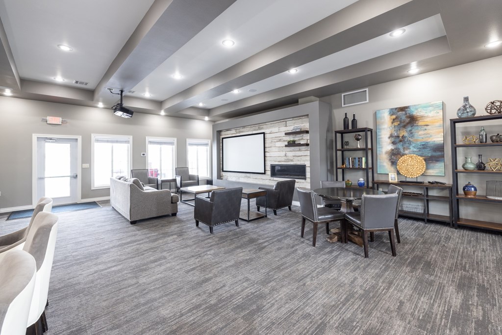 A spacious room with grey carpeting and furniture.
