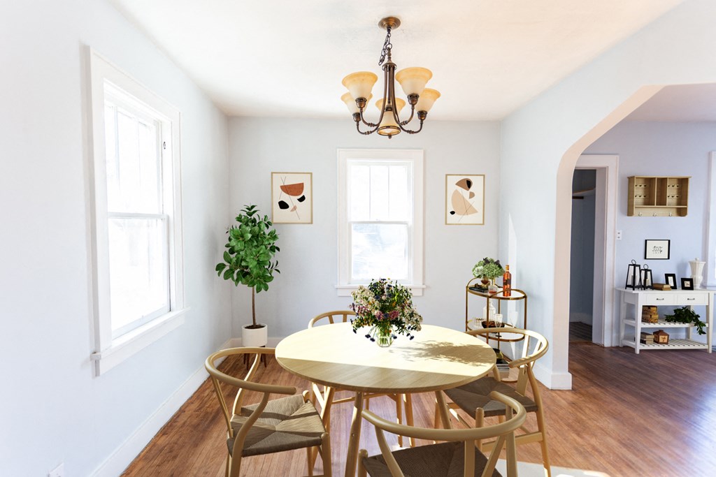 a dining room with a table and chairs and a chandelier