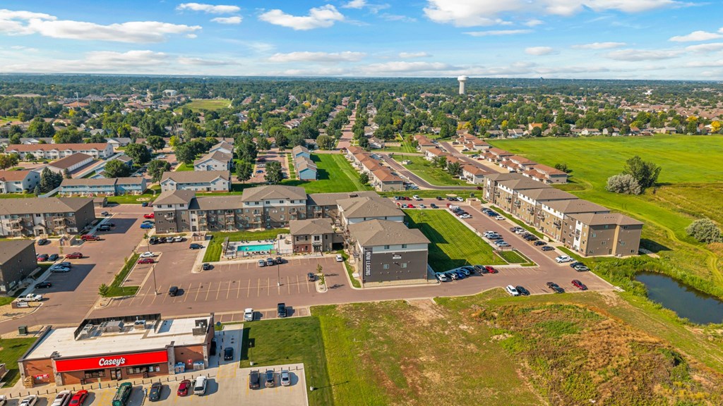 A view of a town from above with a large building in the foreground.