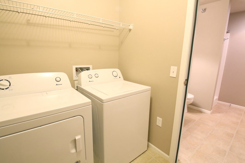 a laundry room with a washer and dryer and a closet