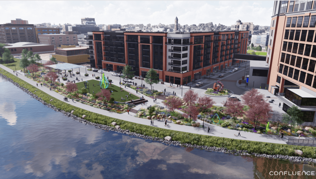 an aerial view of a park with buildings and a river