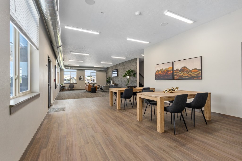 A conference room with a long table and chairs.