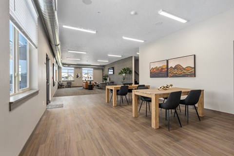 A conference room with a long table and chairs.