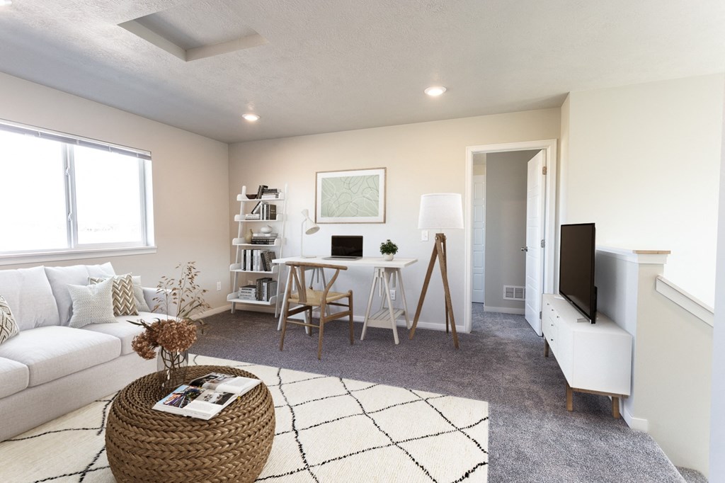 a living room with a white couch and a tv