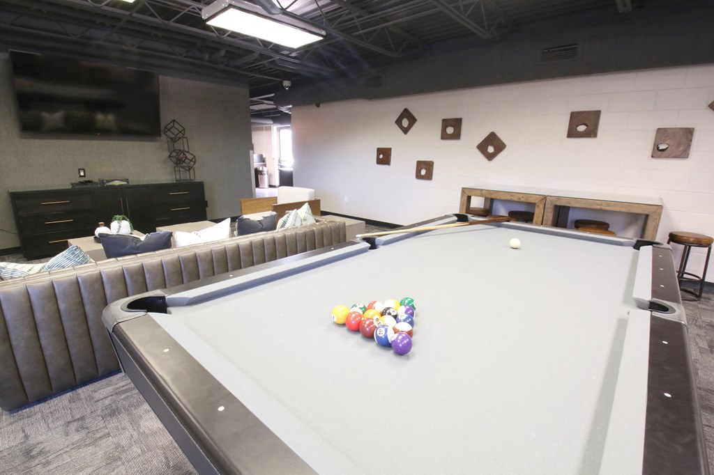a game room with a pool table and a television