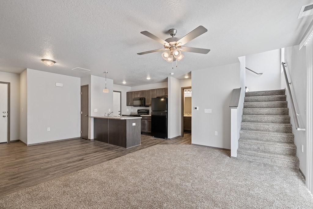 Modern open-concept kitchen and living area with black appliances.