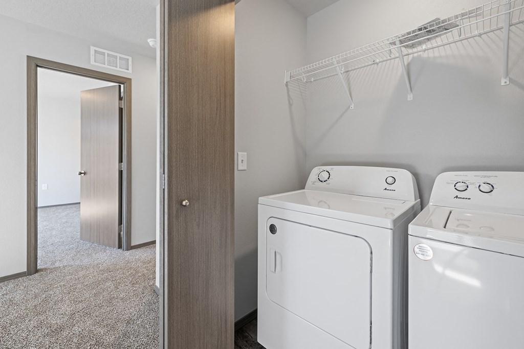 Laundry room with washer and dryer, and built-in cabinets.