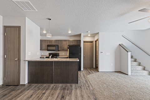 A kitchen with a microwave, oven, and refrigerator.