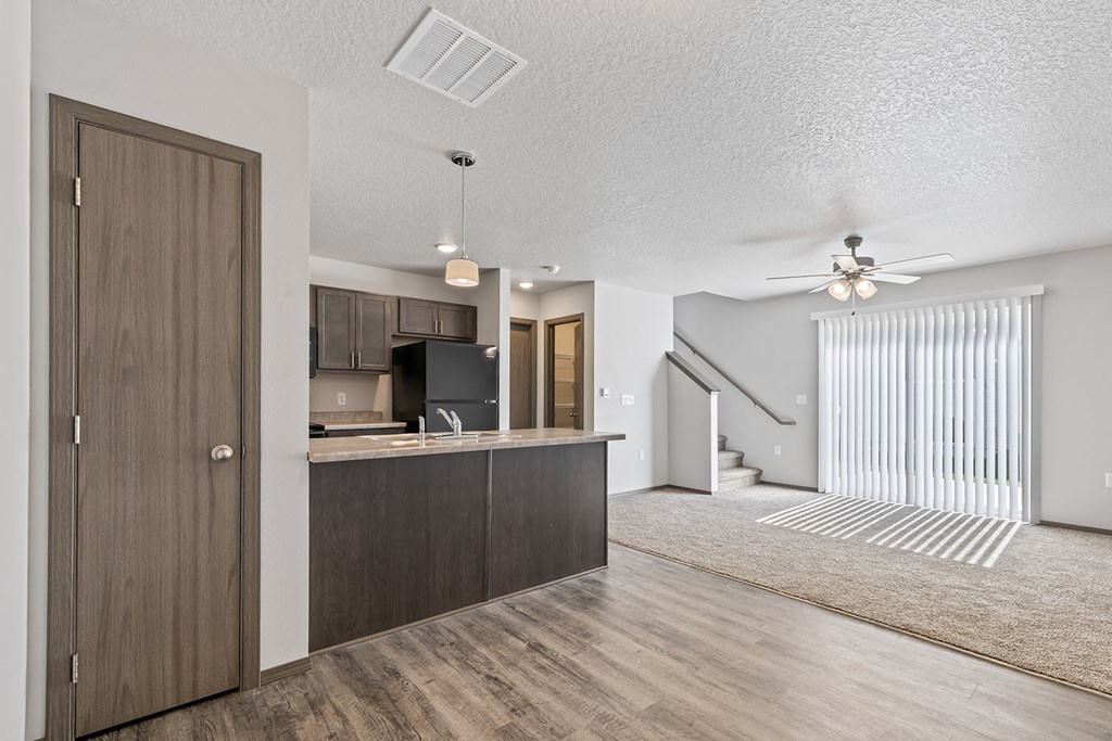 Modern open-concept kitchen and living area with black appliances.