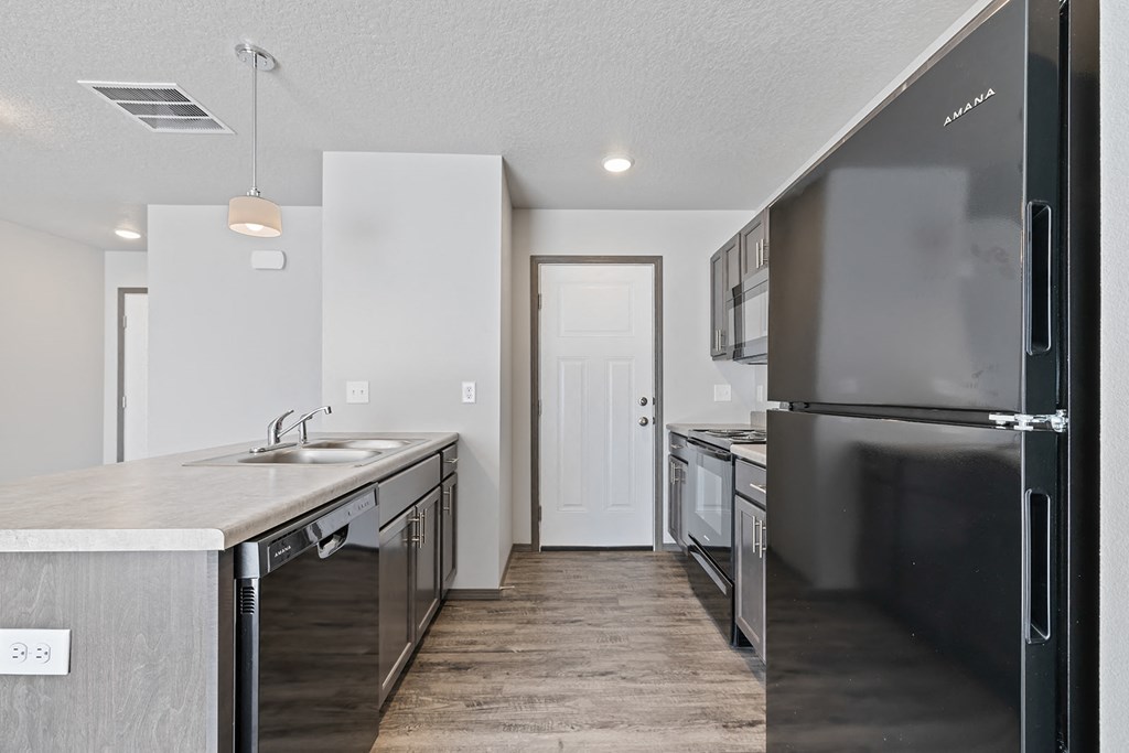 an empty kitchen with stainless steel appliances and a stainless steel refrigerator