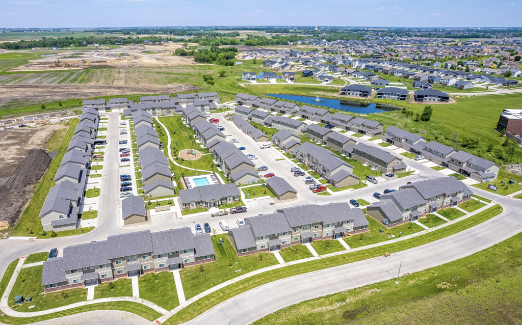 an aerial view of a neighborhood of houses and a parking lot