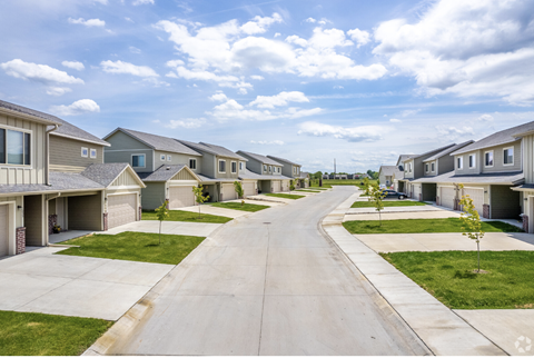 Well-maintained landscaping with manicured shrubs and paved walkways.