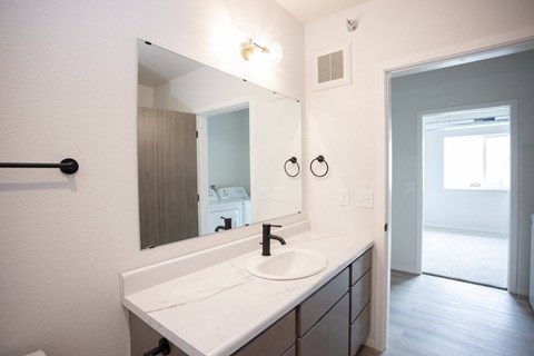 A bathroom with a sink and mirror.