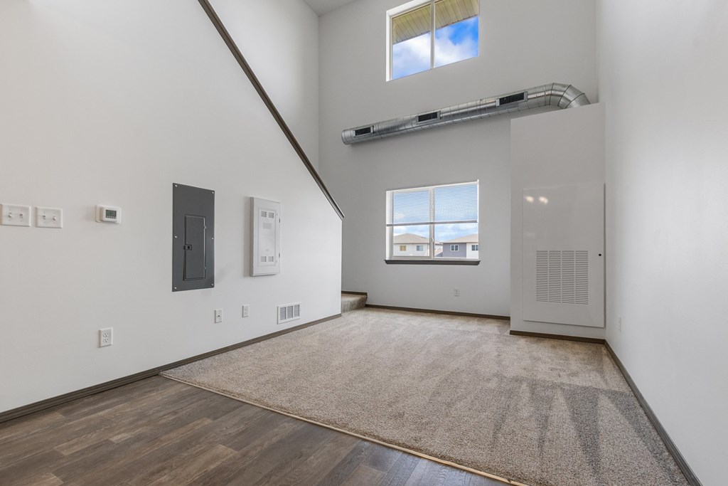 A room with a window and a door on the right side.