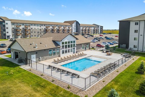 A large building with a pool in front.