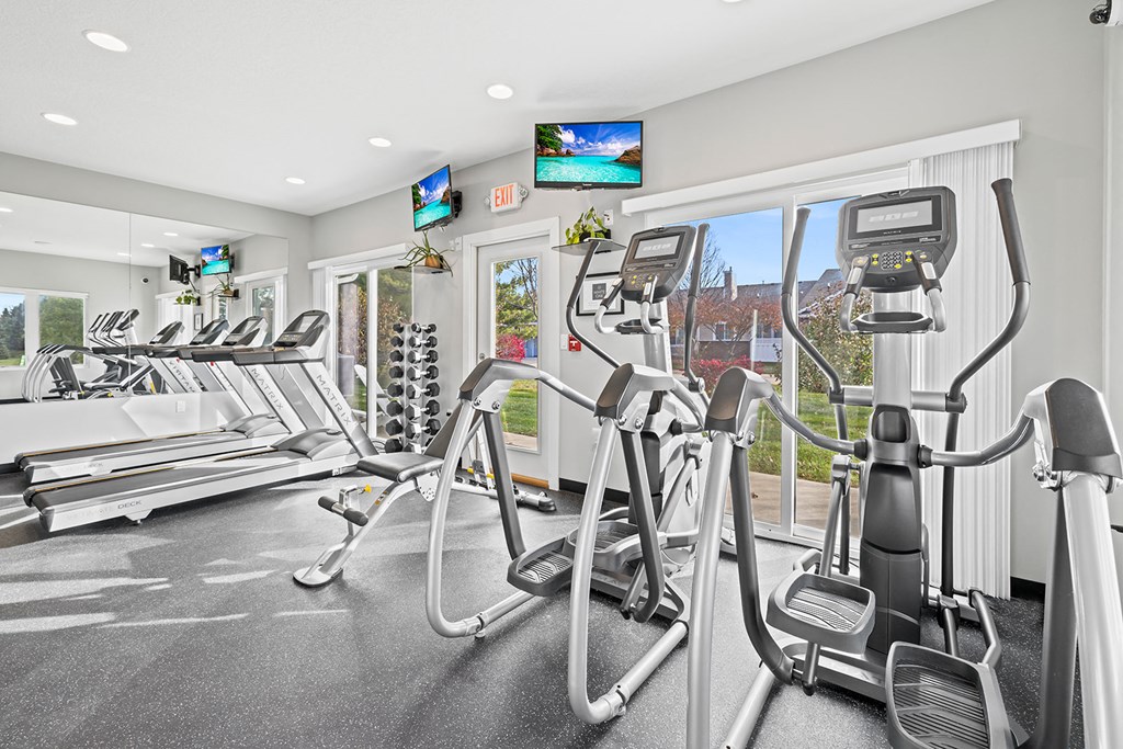 a gym with treadmills and other exercise equipment