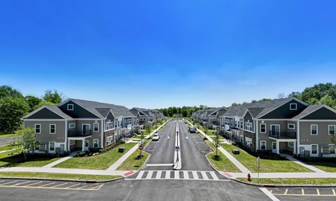 an aerial view of a neighborhood of houses on a street