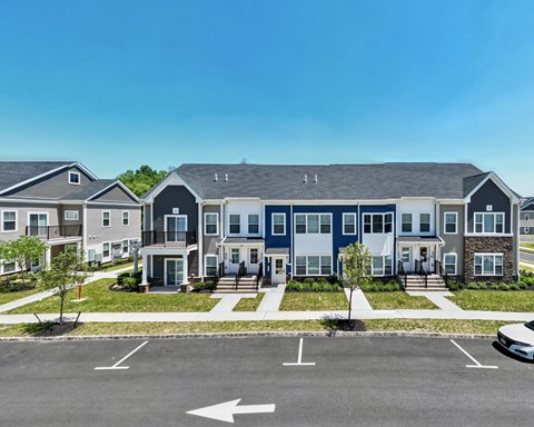 a row of houses on a street with a parking lot