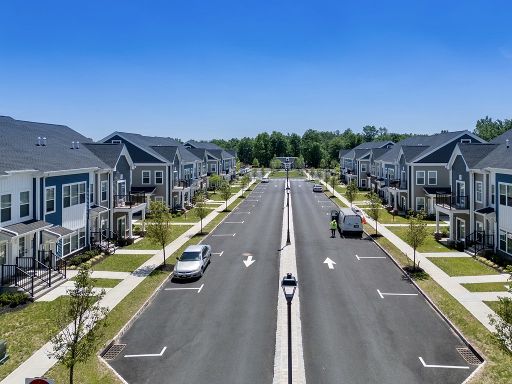 an empty street with rows of houses on either side of it